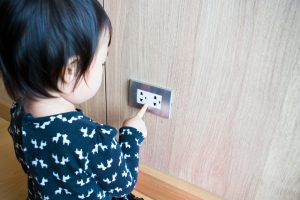 A,Child,Is,Trying,To,Poke,Into,Electrical,Outlets.,Kid